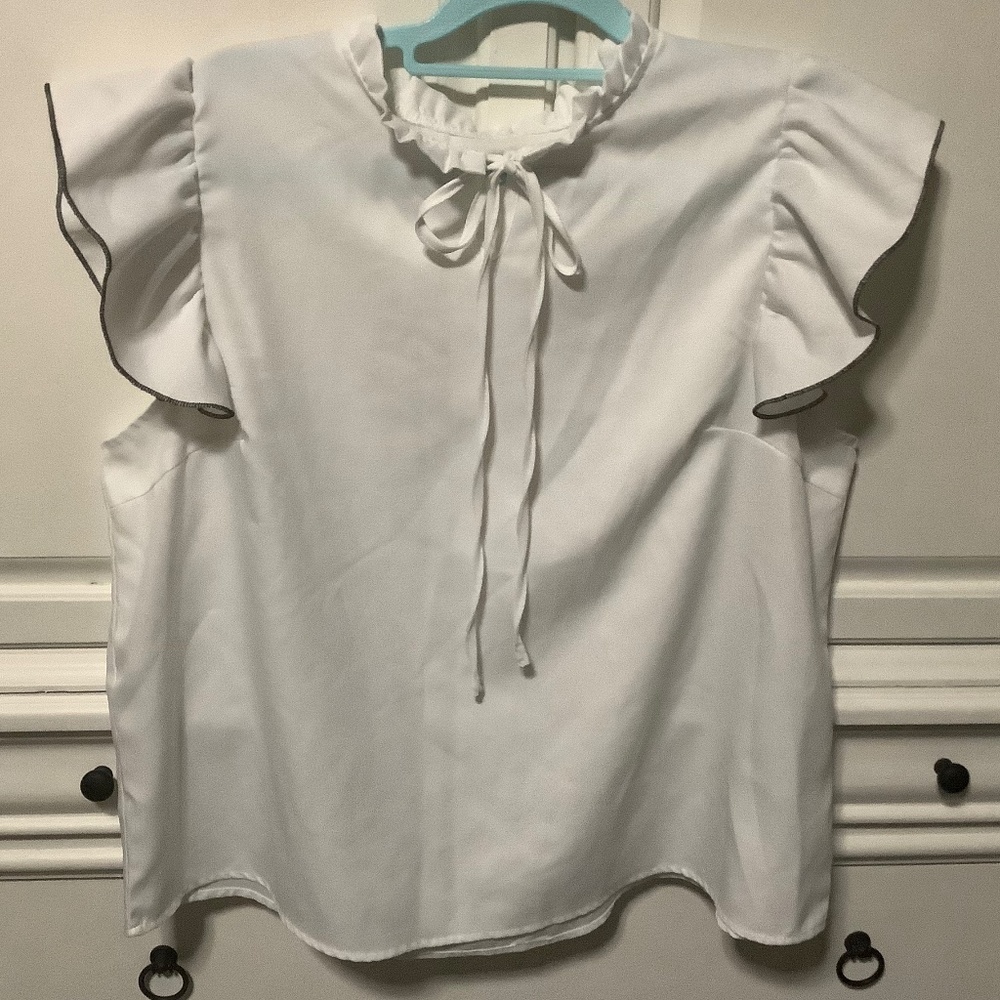 Ladies 1X white pullover blouse with tie at neck, black edge to ruffled sleeve
